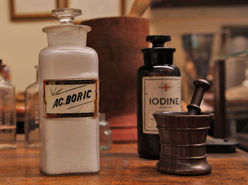 Shelf Ware Bottle containing Boric Acid; Mortar and Pestle; Amber Glass-stoppered Bottle of Iodine Shelf Ware Bottle containing Boric Acid; Mortar and Pestle; Amber Glass-stoppered Bottle of Iodine